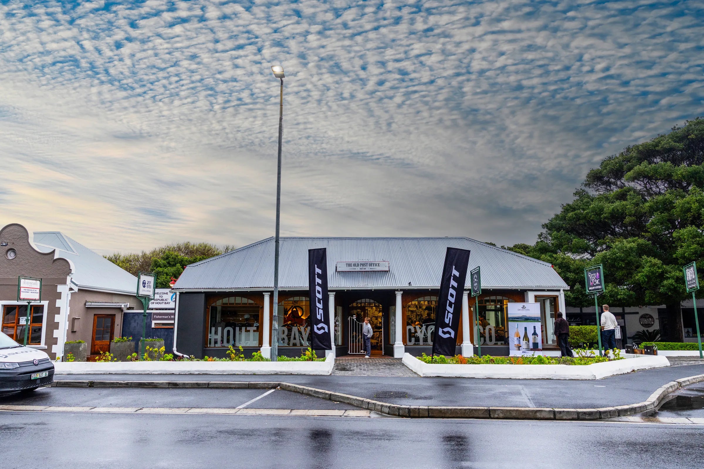Hout Bay Cycle Co in the Old Post Office building on Main Road, Hout Bay, under a mackerel sky after rain